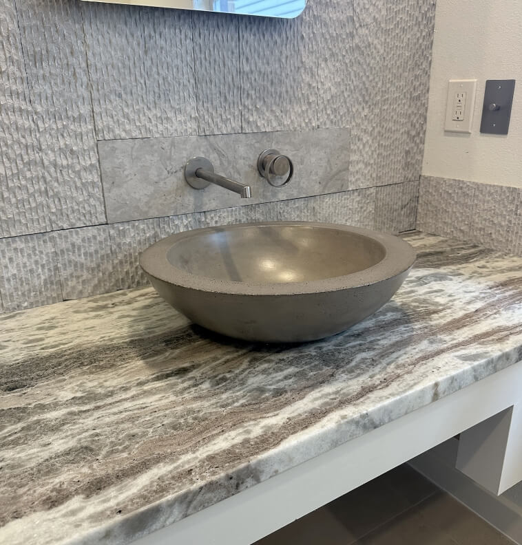 A modern concrete basin on a stylish countertop.